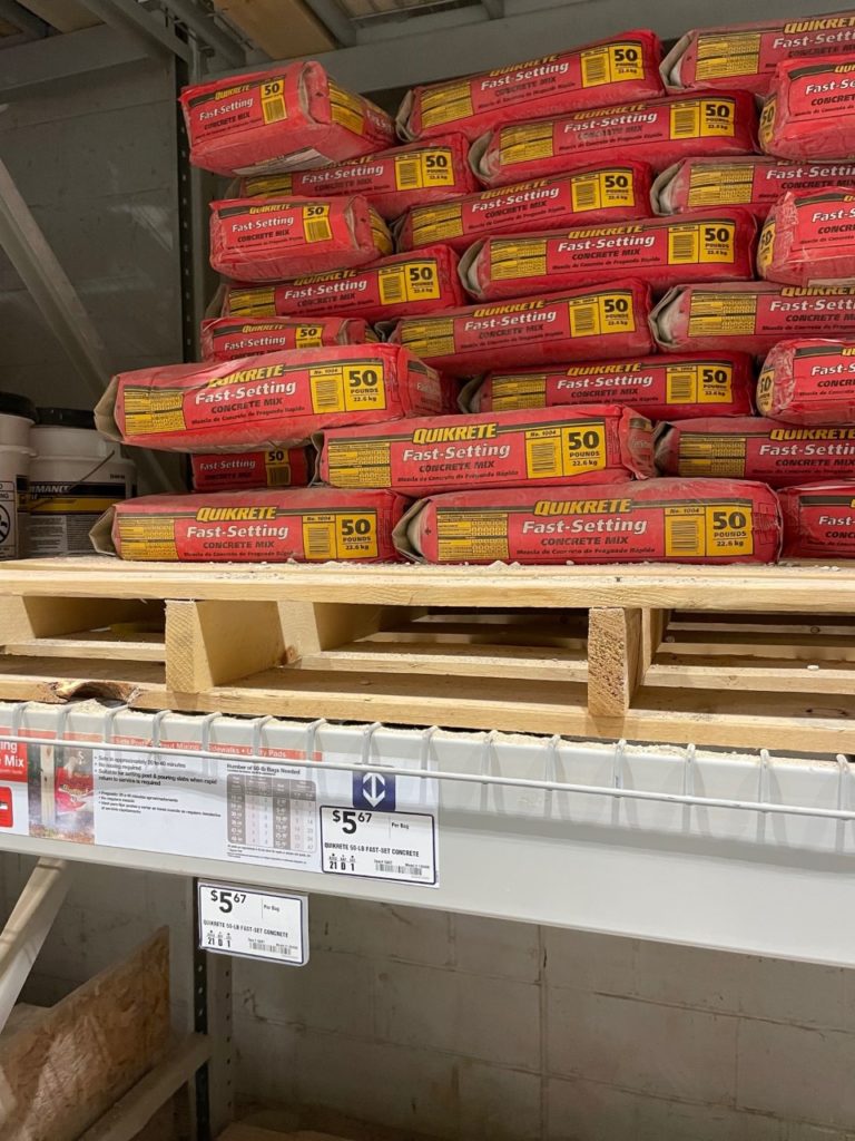 Photo of Quick Set Concrete stacked inside store 
