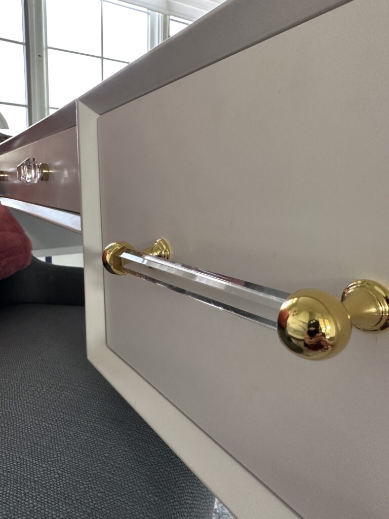 Polished brass and crystal knobs and handles for office desk.
