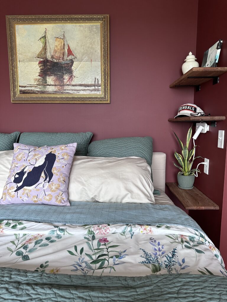 A photo of a nicely made bed against Rustic Red walls.