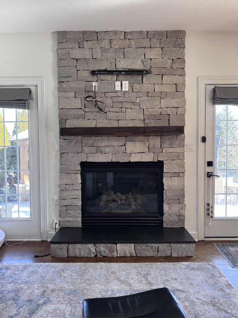 This is the fireplace before the DIY project takes place. You can see there is no mortar between the stones. 